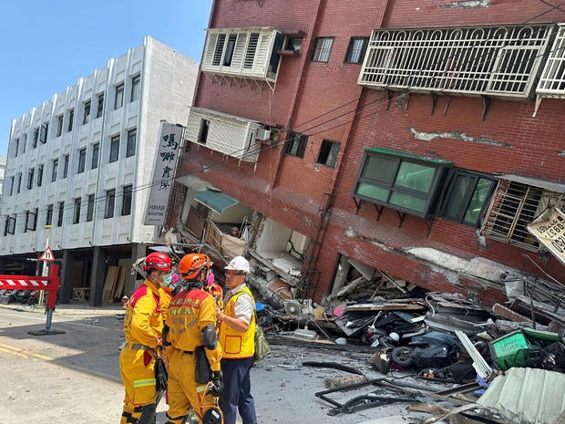 Firefighters work at the site where a building collapsed following the earthquake, in Hualien 